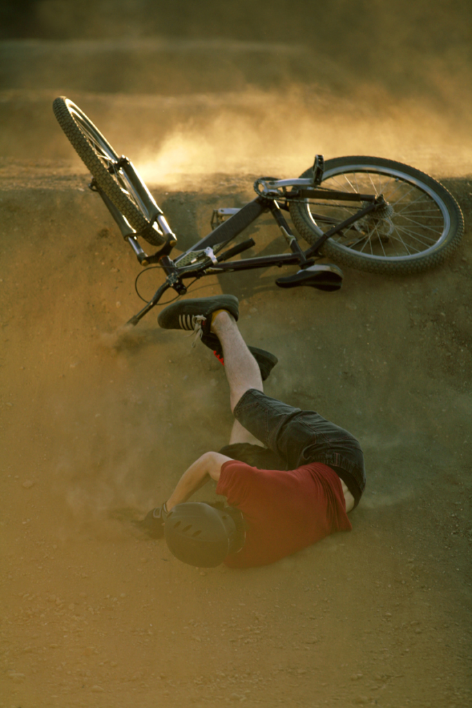 Man falling off of trail bike